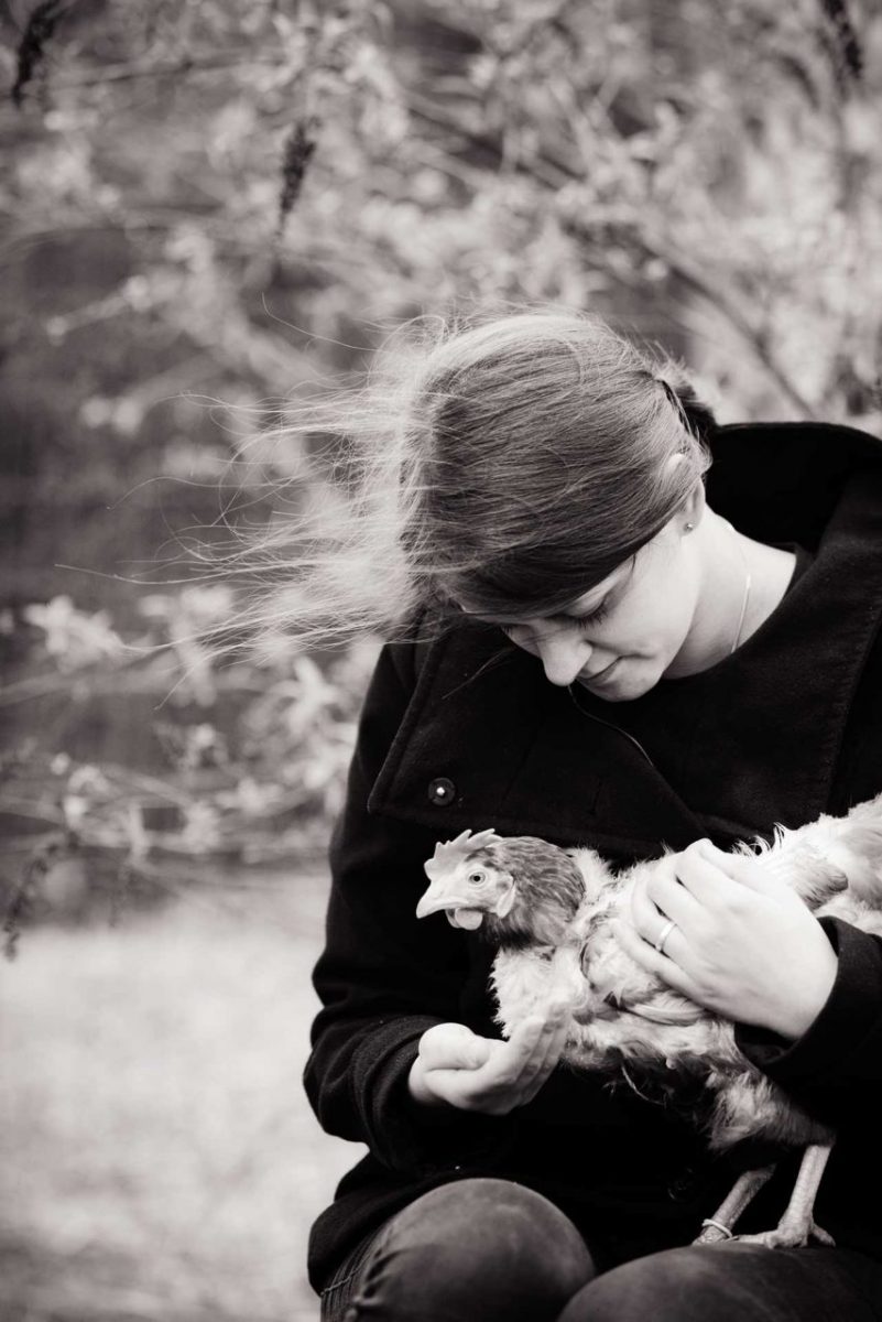 Lina Lind Christensen with a rescued hen at her sanctuary, Frie Vinger (Free Wings). Denmark, 2015